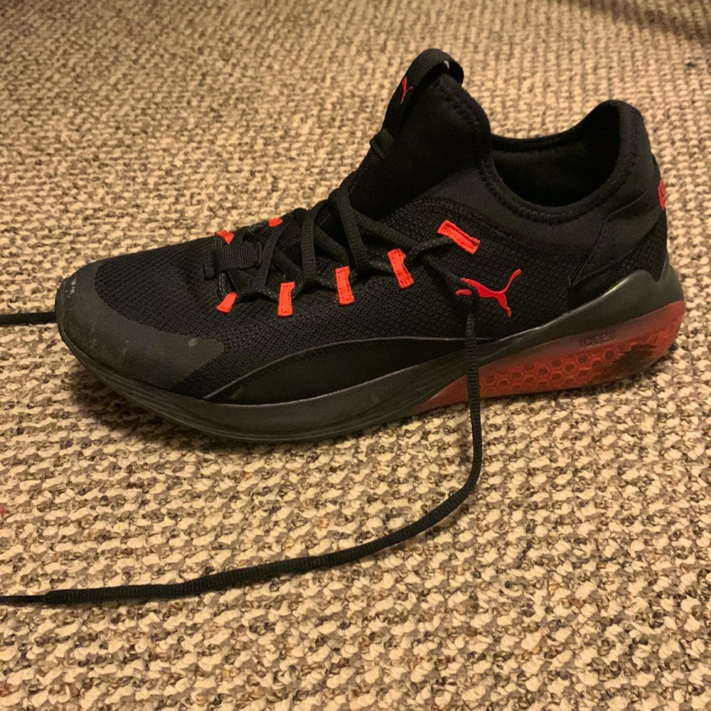 Black and red Puma athletic shoes